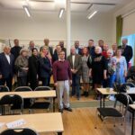 Учасники навчального візиту до Гетеборга стоять групою в залі зі столами та стільцями